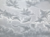 frosty - Ice crystals covering glass window.
